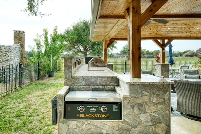 view of patio featuring area for grilling and ceiling fan