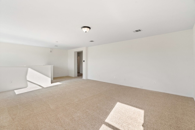 spare room featuring light carpet