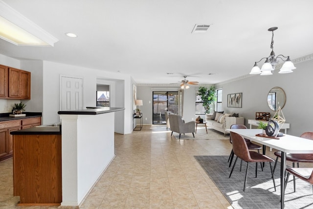 kitchen featuring light tile patterned floors, ceiling fan with notable chandelier, and hanging light fixtures