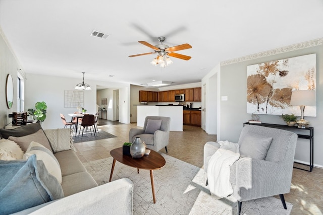 living room with ceiling fan with notable chandelier