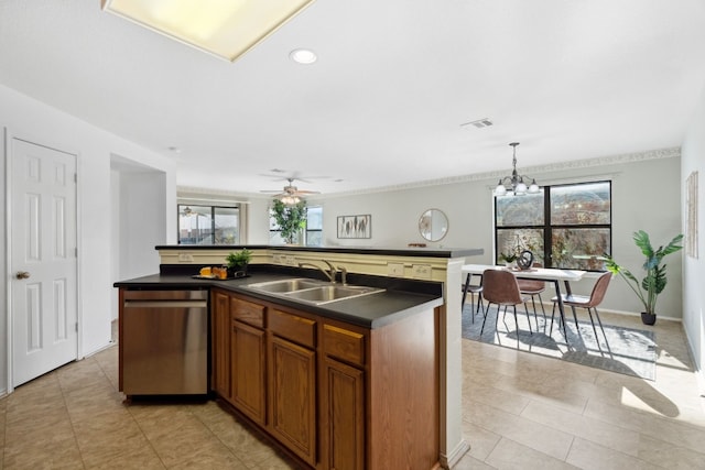 kitchen featuring sink, a wealth of natural light, and an island with sink