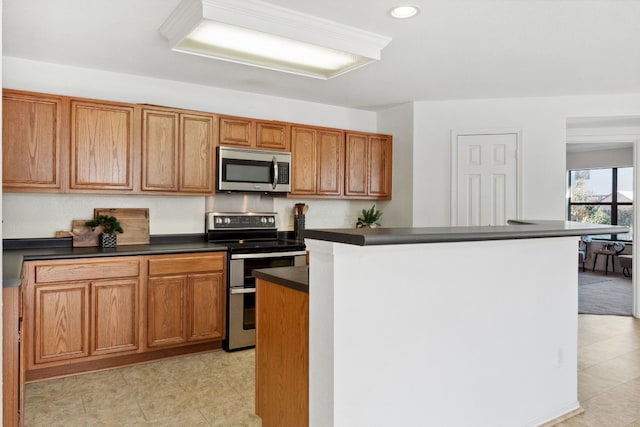 kitchen with appliances with stainless steel finishes and a kitchen island