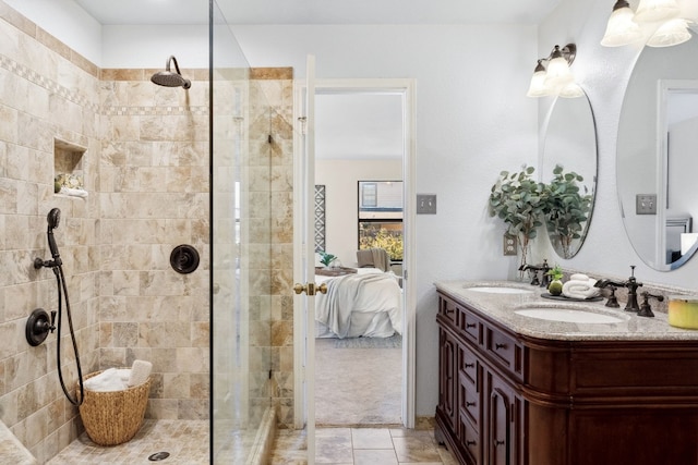 bathroom with tiled shower and vanity