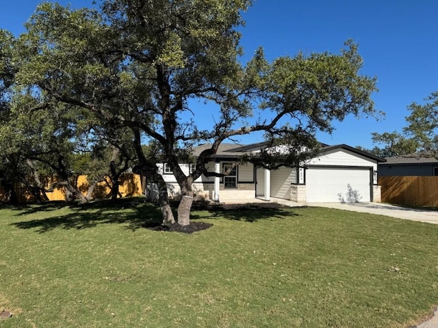 view of front of property featuring a front yard and a garage