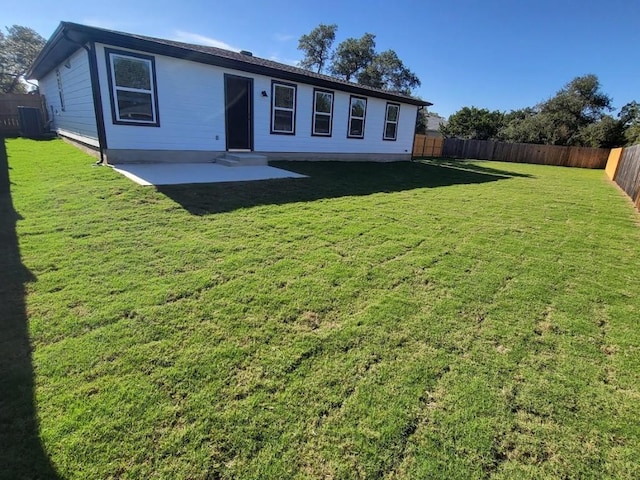 rear view of property with a patio and a lawn