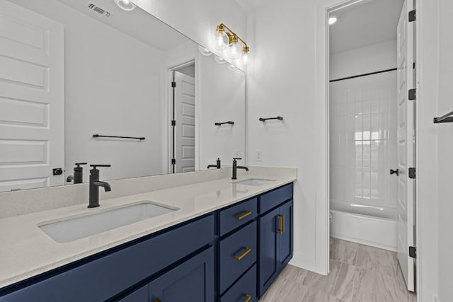 5900 Comanche Moon Trl, Austin, TX 78747 - bathroom with double vanity, shower / washtub combination, and marble look tile flooring