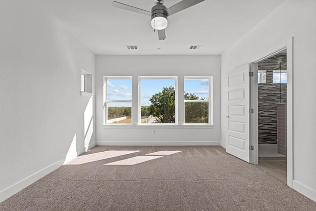 unfurnished bedroom featuring a ceiling fan, carpet flooring, visible vents, and baseboards