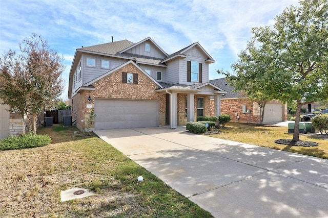 craftsman house with central AC, a front lawn, and a garage