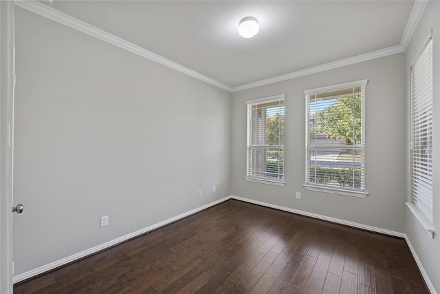 empty room featuring dark hardwood / wood-style floors and ornamental molding