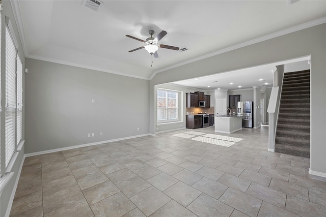 unfurnished living room with light tile patterned flooring, ceiling fan, crown molding, and sink