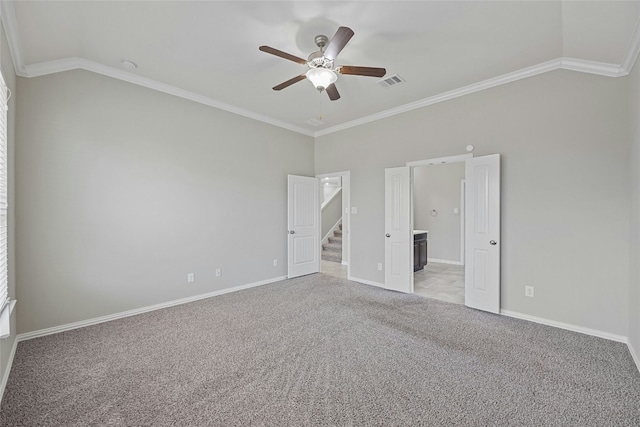 unfurnished room with light carpet, vaulted ceiling, and ornamental molding