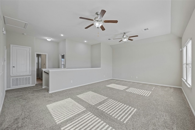 spare room with carpet, vaulted ceiling, and ceiling fan