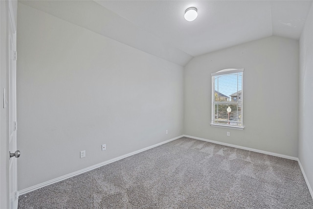 spare room with carpet and lofted ceiling