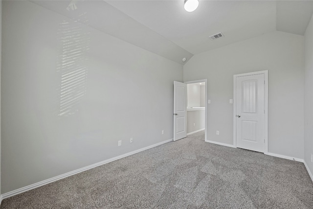 unfurnished bedroom with a closet, carpet floors, and lofted ceiling