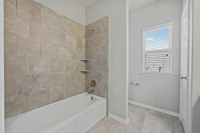 bathroom with tile patterned flooring and tiled shower / bath