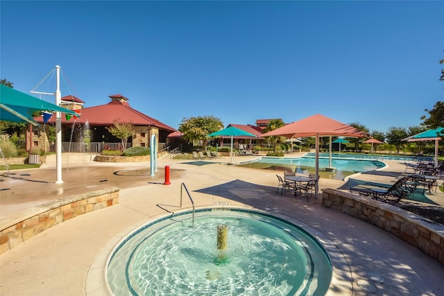 view of pool with a gazebo, a community hot tub, and a patio