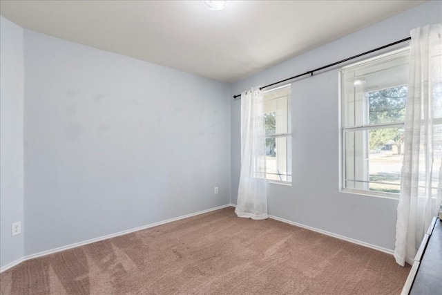 carpeted empty room with a wealth of natural light