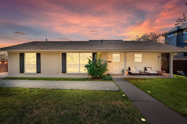 single story home with outdoor lounge area, a yard, and a patio