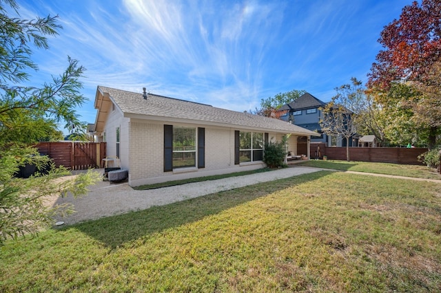 back of property featuring a yard and a patio