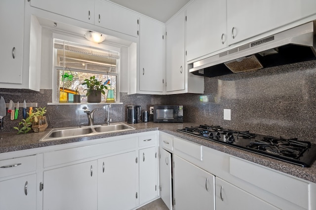 kitchen with backsplash, white cabinetry, sink, and black appliances