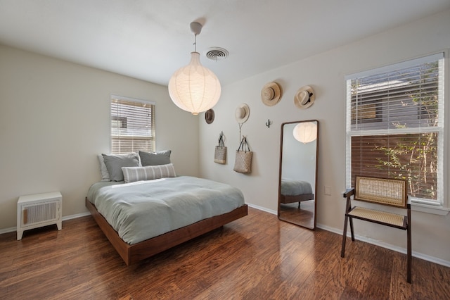 bedroom with dark wood-type flooring