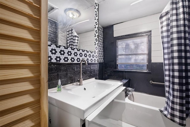 bathroom featuring decorative backsplash, tile walls, and shower / bath combo with shower curtain