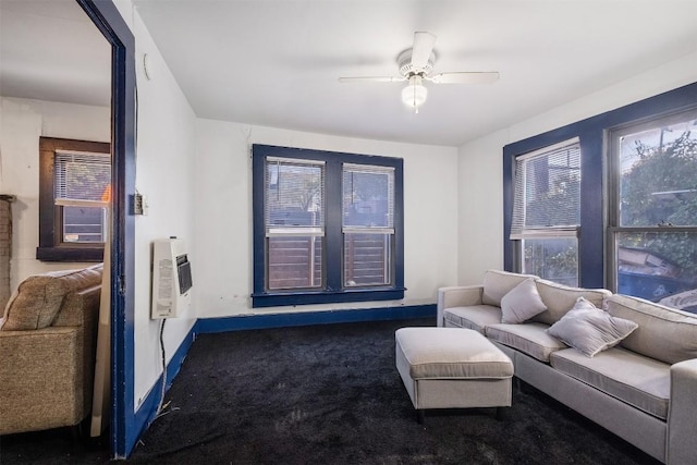 living room with ceiling fan, dark carpet, and heating unit