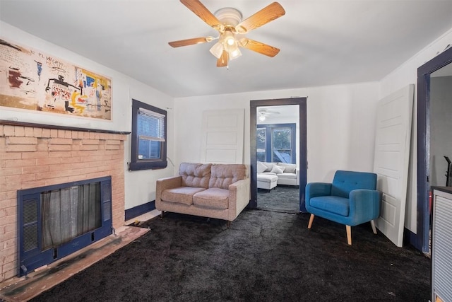 carpeted living room with ceiling fan and a fireplace