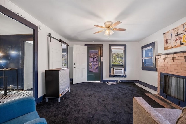 carpeted living room featuring a brick fireplace, ceiling fan, a barn door, and cooling unit