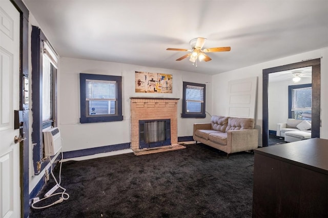 living room with a fireplace, dark carpet, a healthy amount of sunlight, and a wall unit AC