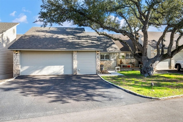 view of front facade with a garage and a front lawn