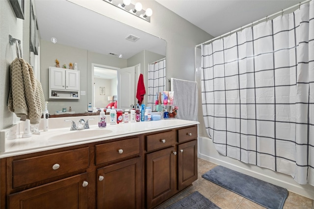 bathroom featuring tile patterned flooring, vanity, and shower / tub combo with curtain