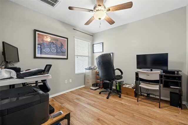 3204 Barksdale Dr, Austin, TX 78725 - home office with wood finished floors, a ceiling fan, and baseboards