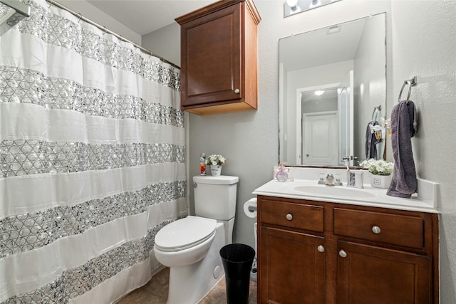 bathroom featuring a shower with curtain, tile patterned flooring, vanity, and toilet