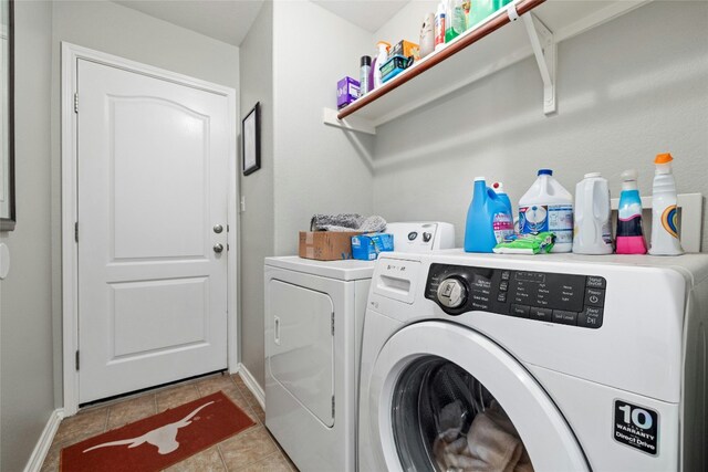 3204 Barksdale Dr, Austin, TX 78725 - laundry room featuring washing machine and dryer, light tile patterned floors, and baseboards