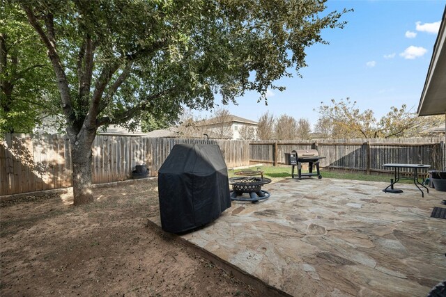 3204 Barksdale Dr, Austin, TX 78725 - fenced backyard with an outdoor fire pit, a patio, and area for grilling