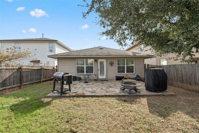3204 Barksdale Dr, Austin, TX 78725 - rear view of property featuring a patio area, an outdoor fire pit, and roof with shingles