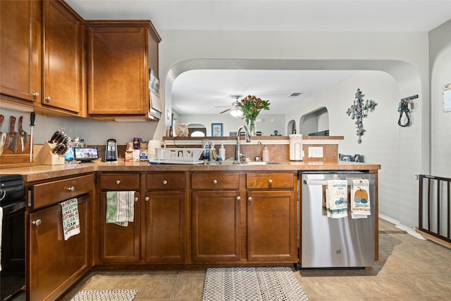 3204 Barksdale Dr, Austin, TX 78725 - kitchen featuring dishwasher, a sink, arched walkways, ceiling fan, and a peninsula