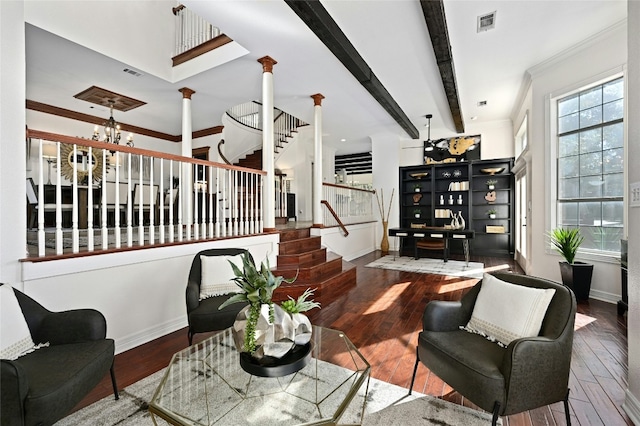 living room with ornate columns, beam ceiling, ornamental molding, stairs, and wood-type flooring