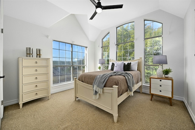 bedroom featuring baseboards, lofted ceiling, light colored carpet, and ceiling fan