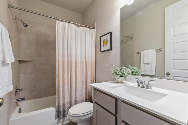 full bathroom with shower / tub combo with curtain, vanity, and toilet