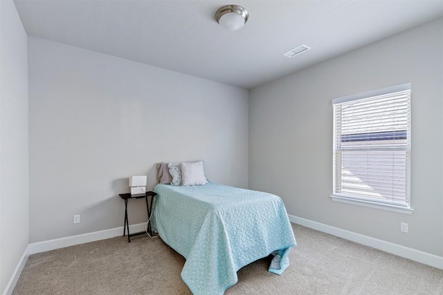 bedroom with light colored carpet