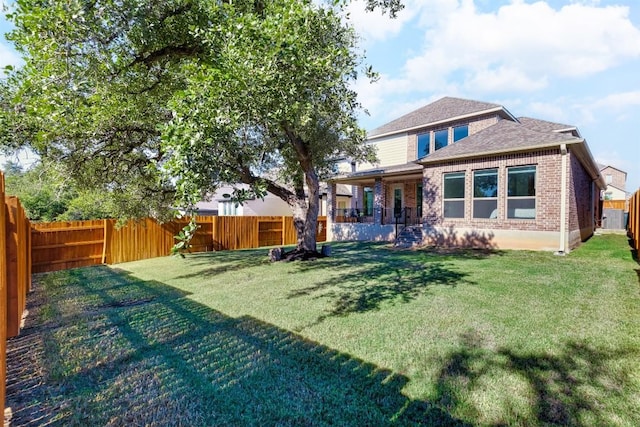 rear view of property featuring a yard