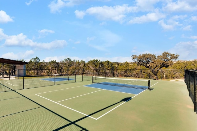 view of tennis court with basketball hoop