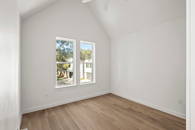 spare room featuring ceiling fan, vaulted ceiling, and light hardwood / wood-style flooring