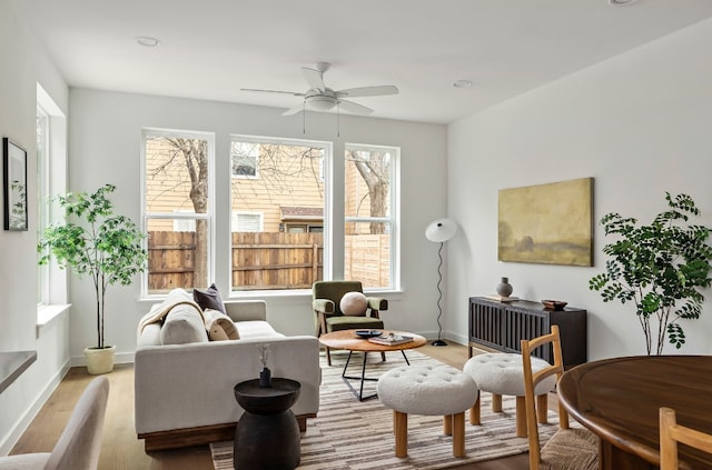 sitting room featuring light wood finished floors, ceiling fan, baseboards, and recessed lighting