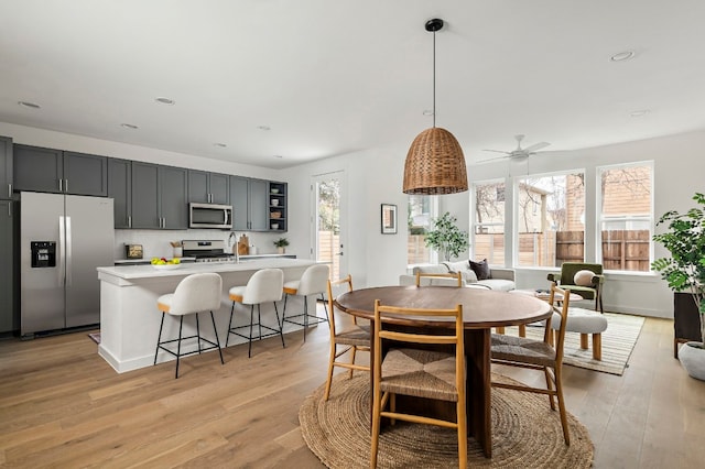 dining space featuring plenty of natural light, light wood-style floors, a ceiling fan, and recessed lighting