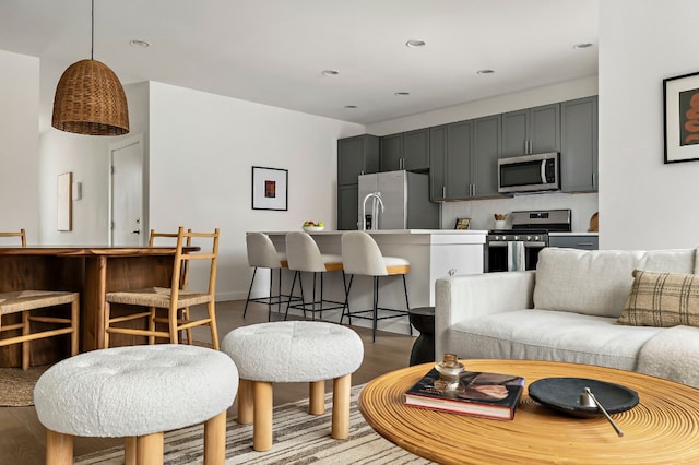 living area with light wood-style floors and recessed lighting