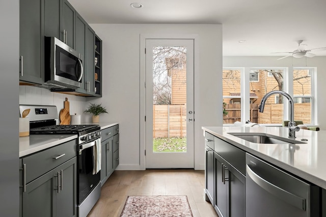 5107 Menchaca Rd Unit 4, Austin, TX 78745 - kitchen featuring stainless steel appliances, light countertops, light wood finished floors, recessed lighting, and ceiling fan