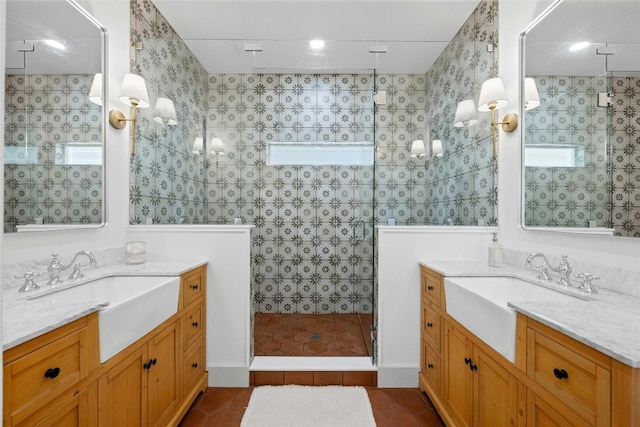 bathroom with tiled shower, vanity, tile patterned floors, and tile walls